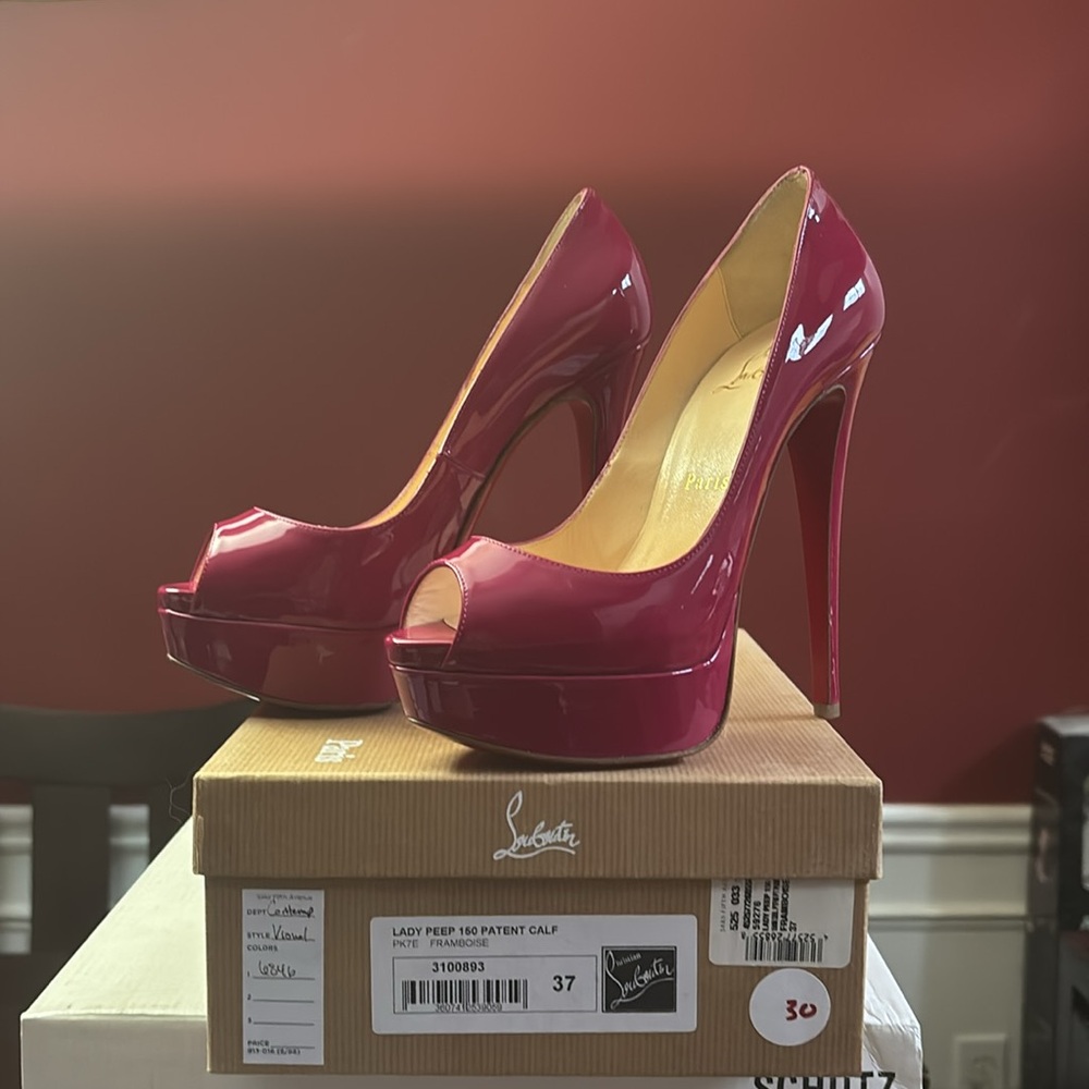 Christian Louboutin “framboise” patent leather platform stiletto heels.